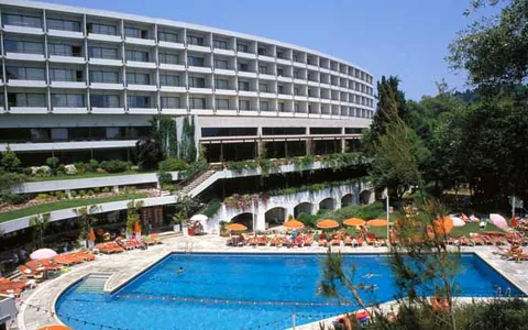 The curved hotel building and swimming pool at Corfu Holiday Palace.