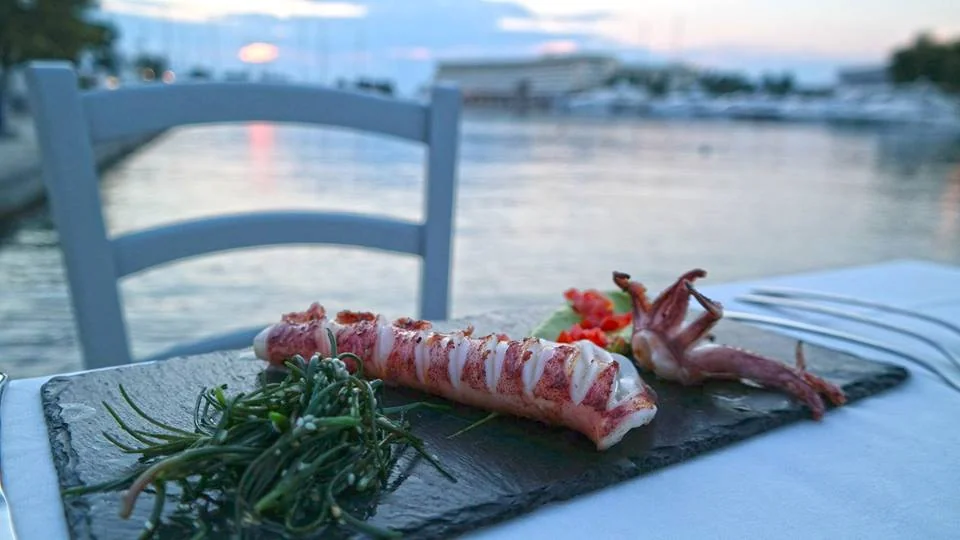 A seafood dish on a waterfront restaurant table at Porto Carras, Chalkidiki.