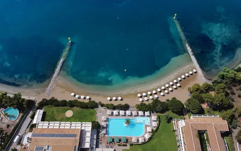Aerial view of the pool, beachfront and breakwaters at Negroponte Resort Eretria.