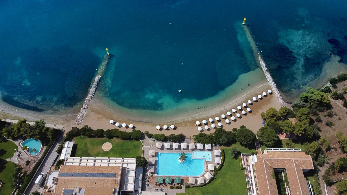 Aerial view of the pool, beachfront and breakwaters at Negroponte Resort Eretria.